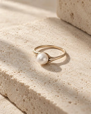 Pearl ring displayed in soft natural light.