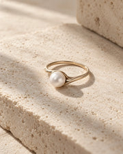 Pearl ring displayed in soft natural light.